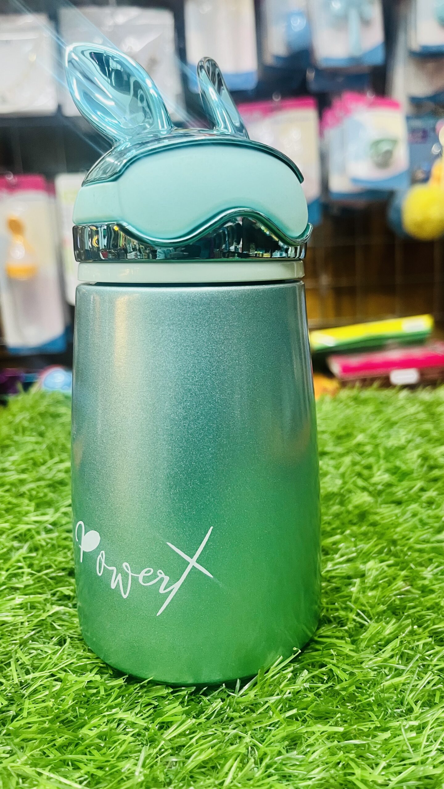 cute bunny ears insulated stainless steel mini water bottle (metallic green & bronze gold, 300 ml) Front view of metallic green cute bunny ears insulated stainless steel mini water bottle on green grass