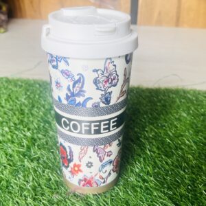 Home Overhead close up of floral travel coffee mug showing open silicone flip straw drinking spout