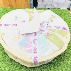 Home Top down view of Mommas Baby 10 pcs newborn baby gift heart basket set wrapped in clear film with ribbon on grass